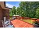 Relaxing wooden deck with white rocking chairs overlooking the backyard and surrounding trees at 10501 Mount Olive Dr # 7, Mount Pleasant, NC 28124