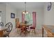 Charming dining area with wood table, chairs, chandelier, and bright natural light from the window at 10501 Mount Olive Dr # 7, Mount Pleasant, NC 28124