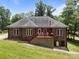 Brick home featuring a covered porch with rocking chairs, well-maintained lawn and mature trees at 10501 Mount Olive Dr # 7, Mount Pleasant, NC 28124