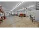This garage contains an orange tractor, work benches, and plenty of storage space at 10501 Mount Olive Dr # 7, Mount Pleasant, NC 28124