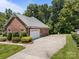 Side view of a brick home with an attached garage and a wide concrete driveway at 10501 Mount Olive Dr # 7, Mount Pleasant, NC 28124