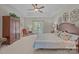 Bright bedroom features a ceiling fan and large wardrobe at 10501 Mount Olive Dr # 7, Mount Pleasant, NC 28124