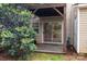 View of a backyard patio highlighting the home's door, window, and surrounding yard at 10548 English Setter Way, Charlotte, NC 28269