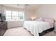 Well-lit bedroom with natural light, ceiling fan, and neutral carpet at 10548 English Setter Way, Charlotte, NC 28269
