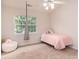 Bright bedroom featuring a hanging chair, pink decor, and natural light at 10548 English Setter Way, Charlotte, NC 28269
