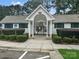 Front view of clubhouse entrance with gated access and accessible parking spaces at 10548 English Setter Way, Charlotte, NC 28269