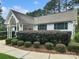 Exterior view of clubhouse featuring white siding, green shutters, and mature landscaping in front at 10548 English Setter Way, Charlotte, NC 28269