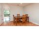 Dining area with hardwood floors, a wooden table, and four chairs near a glass door at 10548 English Setter Way, Charlotte, NC 28269