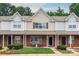 Charming townhome features brick facade, well-maintained landscaping, and cozy front porch at 10548 English Setter Way, Charlotte, NC 28269