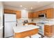 Functional kitchen features light wood cabinets, a center island, and essential appliances at 10548 English Setter Way, Charlotte, NC 28269