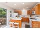 Bright kitchen featuring light wood cabinets, a center island, and modern appliances at 10548 English Setter Way, Charlotte, NC 28269