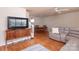 Spacious living room with hardwood floors, a large TV, and dining area at 10548 English Setter Way, Charlotte, NC 28269
