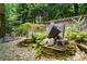 Landscaped backyard with unique waterfall feature and rock accents at 10607 Newberry Park Ln, Charlotte, NC 28277