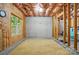 Unfinished basement space with exposed ceiling, framing, concrete floor, and light-filled window at 10607 Newberry Park Ln, Charlotte, NC 28277