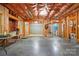 Unfinished basement space with exposed ceiling, framing, concrete floor, and light-filled windows at 10607 Newberry Park Ln, Charlotte, NC 28277