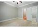 Neutral bedroom with carpet flooring, ceiling fan, and closet with great natural light at 10607 Newberry Park Ln, Charlotte, NC 28277