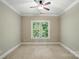 Bright and airy bedroom with carpet flooring, ceiling fan, and large window at 10607 Newberry Park Ln, Charlotte, NC 28277