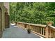 Outdoor deck with wood railing, plants, and view of yard at 10607 Newberry Park Ln, Charlotte, NC 28277