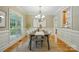 Inviting dining room with a long table, neutral palette, and large window that provides natural light at 10607 Newberry Park Ln, Charlotte, NC 28277