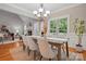 Elegant dining room with stylish chandelier, fireplace, and ample seating for memorable Gathering meals at 10607 Newberry Park Ln, Charlotte, NC 28277
