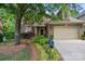 Charming brick home with manicured landscaping, a garage, and mailbox at 10607 Newberry Park Ln, Charlotte, NC 28277