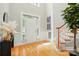 Bright foyer with hardwood floors, staircase, and a decorative plant at 10607 Newberry Park Ln, Charlotte, NC 28277