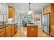Spacious kitchen with stainless steel appliances, granite countertops, island, and adjacent breakfast area at 10607 Newberry Park Ln, Charlotte, NC 28277