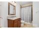 Bathroom featuring a vanity with granite countertop and a tile shower with curtain at 10874 Rise Ln, Fort Mill, SC 29707