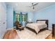 Bedroom with hardwood floors, large windows, a ceiling fan, and light blue walls at 10874 Rise Ln, Fort Mill, SC 29707