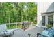 Exterior view of deck featuring grill, seating, and mature trees at 10874 Rise Ln, Fort Mill, SC 29707