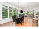 Bright dining area with a wood table and chairs, large windows, and a glimpse into the living room at 10874 Rise Ln, Fort Mill, SC 29707