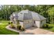 Charming home exterior featuring a gray roof, a two-car garage, and professional landscaping at 10874 Rise Ln, Fort Mill, SC 29707