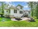 Exterior view of home's backyard featuring patio, fire pit, and well manicured lawn at 10874 Rise Ln, Fort Mill, SC 29707