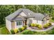 Inviting exterior showcasing a well-maintained lawn and charming curb appeal with stone and siding accents at 10874 Rise Ln, Fort Mill, SC 29707