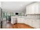 Bright, open kitchen featuring white cabinets, granite countertops, stainless steel appliances, and hardwood floors at 10874 Rise Ln, Fort Mill, SC 29707