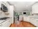 Bright kitchen area with white cabinets, stainless steel appliances, and an open view to the dining area at 10874 Rise Ln, Fort Mill, SC 29707