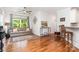 Open-concept living room features hardwood floors, neutral couch, large windows, and modern decor at 10874 Rise Ln, Fort Mill, SC 29707