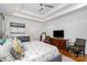 Main bedroom with a trey ceiling, ceiling fan, and hardwood floors at 10874 Rise Ln, Fort Mill, SC 29707