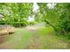 Expansive backyard with a wooden deck and lush greenery, perfect for outdoor activities at 110 Eighth St, York, SC 29745