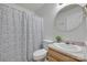 Well-lit bathroom features a functional layout and a shower with decorative curtain at 110 Eighth St, York, SC 29745
