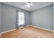 Well-lit bedroom features wood floors, a ceiling fan, and large window at 110 Eighth St, York, SC 29745