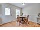 Cozy dining area with light wood floors, a round table, and a back door view at 110 Eighth St, York, SC 29745