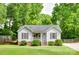 Charming single-story home with well-manicured lawn, covered front porch, and lush green trees at 110 Eighth St, York, SC 29745