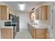 Well-lit kitchen features stainless steel appliances, light wood cabinets, and ample counter space at 110 Eighth St, York, SC 29745