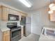 Well-lit kitchen features stainless steel appliances, light wood cabinets, and ample counter space at 110 Eighth St, York, SC 29745