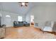 Bright living room featuring vaulted ceilings, gray sofa and chair with light wood floors at 110 Eighth St, York, SC 29745