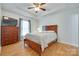 Comfortable main bedroom with a ceiling fan, wood floors, and a large window for plenty of natural light at 110 Eighth St, York, SC 29745