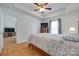 Comfortable main bedroom with a ceiling fan, wood floors, and a large window for plenty of natural light at 110 Eighth St, York, SC 29745