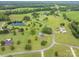 Aerial showing the property's expansive lot with a pool, pond, mature trees, and country landscape at 112 Ocean Dr, Shelby, NC 28152