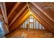 Spacious attic with exposed beams, a round window, and potential for storage or conversion at 112 Ocean Dr, Shelby, NC 28152